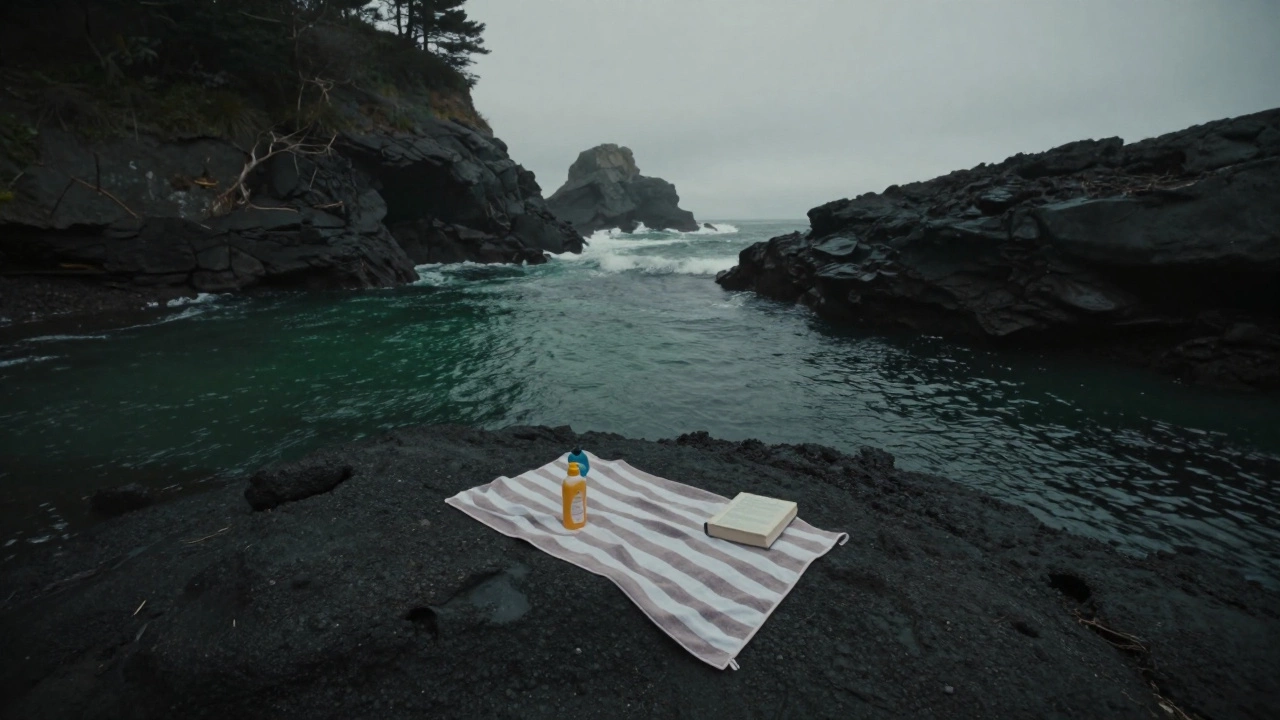 A lonely towel and sunscreen on a rocky beach in a misty Northern California cove